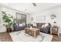 Cozy living room featuring plush seating, decorative throw pillows, and a large area rug at 69 E Benrich Dr, Gilbert, AZ 85295