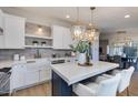Bright, open kitchen with pendant lighting, quartz countertops, and modern appliances at 8031 E Redwing Rd, Scottsdale, AZ 85250