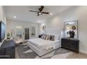 This main bedroom has a plush bed with an en-suite bathroom and access to the outdoor patio at 8031 E Redwing Rd, Scottsdale, AZ 85250