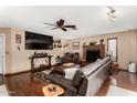 Comfortable living room with hardwood floors, brick fireplace, and large TV, perfect for entertaining at 823 W El Prado Rd, Chandler, AZ 85225