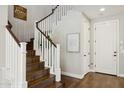 Elegant staircase with wood treads, white risers, and a beautifully adorned entry at 937 W Glacier Dr, Chandler, AZ 85248