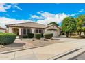 Inviting single-story home with a desert landscaped yard and brick pathway leading to the front entrance at 9715 E Osage Ave, Mesa, AZ 85212
