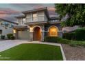 Beautiful two-story home with stone accents, an arched entry, and well-manicured landscaping at 11544 W Ashby Dr, Peoria, AZ 85383