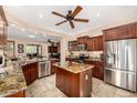 A gourmet kitchen features custom cabinetry, granite countertops, stainless steel appliances, and a center island at 13064 W Big Oak St, Peoria, AZ 85383