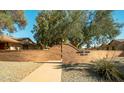 Elegant community entrance featuring a decorative brick wall and beautifully maintained landscaping, creating a welcoming atmosphere at 13275 W Bolero Dr, Sun City West, AZ 85375