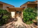 Inviting front porch featuring a cozy seating area, lush greenery, and a well-maintained walkway leading to the entrance at 13275 W Bolero Dr, Sun City West, AZ 85375
