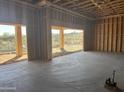 Three car garage under construction with open framing, cement floor, and bright natural light at 13515 N Granite Way, Fountain Hills, AZ 85268