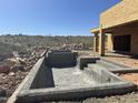 Home under construction featuring a new pool, in ground, surrounded by rocky landscape at 13515 N Granite Way, Fountain Hills, AZ 85268