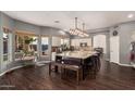 Open-concept kitchen features granite countertops, pendant lighting, and a large center island with seating at 1449 W Commerce Ave, Gilbert, AZ 85233