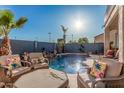 Inviting pool area with comfortable seating and lush landscaping, creating a private outdoor oasis at 1449 W Commerce Ave, Gilbert, AZ 85233