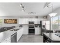 Bright kitchen with white cabinets, stainless steel appliances, and a spacious countertop with modern finishes at 1475 E Runaway Bay Dr, Chandler, AZ 85249