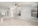 Bright living room with high ceilings, a ceiling fan, and tile flooring; a doorway leads to the kitchen at 1552 E Shannon St, Chandler, AZ 85225