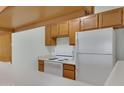 A functional kitchen includes essential appliances, wooden cabinetry, and ample counter space at 1942 S Emerson -- # 127, Mesa, AZ 85210