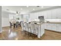 Modern eat-in kitchen with white cabinets, stainless steel appliances, and a center island with bar stool seating at 2483 E Narrowleaf Dr, Gilbert, AZ 85298