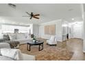 Bright and airy living room featuring hardwood floors, a ceiling fan and an open floor plan at 2483 E Narrowleaf Dr, Gilbert, AZ 85298