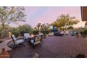Spacious backyard with mature trees, comfortable seating, and a cozy fire pit at 32215 N 16Th Ave, Phoenix, AZ 85085