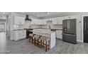 Bright kitchen features white cabinets, granite counters, stainless appliances, and an eat-in island at 3516 E Earll Dr, Phoenix, AZ 85018