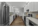 Galley kitchen featuring white cabinets, stainless steel appliances, and modern countertops at 4228 N 87Th St, Scottsdale, AZ 85251