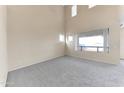 Inviting living room featuring neutral carpeting, high ceilings and lots of natural light at 4234 S 62Nd Ln, Phoenix, AZ 85043