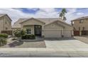 Charming single-story home with a three-car garage, desert landscaping, and an inviting covered entrance at 43271 W Mcclelland Dr, Maricopa, AZ 85138
