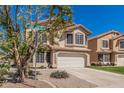 Charming two-story home with a tile roof, lush lawn, and an attached two-car garage at 439 N Cobblestone St, Gilbert, AZ 85234