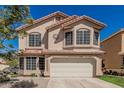 Charming two-story home with a tile roof, lush lawn, and an attached two-car garage at 439 N Cobblestone St, Gilbert, AZ 85234