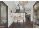 Charming foyer with views to the living and dining area features dark wood floors and modern finishes at 4446 E Camelback Rd # 104, Phoenix, AZ 85018