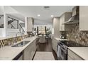 Modern kitchen with stainless steel appliances and eat in dining area and views to the living room at 4446 E Camelback Rd # 104, Phoenix, AZ 85018