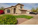 Charming two-story home featuring a well-manicured lawn, desert landscaping, and an attached two-car garage at 4604 E Summerhaven Dr, Phoenix, AZ 85044