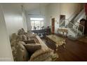 Spacious living room featuring elegant furnishings, a staircase, and hardwood floors at 4604 E Summerhaven Dr, Phoenix, AZ 85044