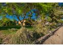 Lovely home with lush greenery, mature trees, and attractive landscaping at 4612 W Waltann W Ln, Glendale, AZ 85306