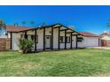 Charming single-story home featuring a well-maintained front lawn and a two-car garage at 4728 N 61St Ave, Phoenix, AZ 85033