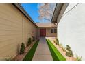 Inviting walkway to the front door with charming landscaping and manicured lawn at 4901 W Augusta Cir, Glendale, AZ 85308