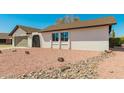 Close-up view of house showcasing the gravel front yard, house facade, and well-maintained landscaping at 4901 W Augusta Cir, Glendale, AZ 85308