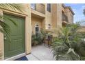 Private courtyard with a green entry door, tropical foliage and patio seating at 5015 E Cheyenne Dr # 10, Phoenix, AZ 85044