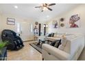 Inviting living room with tile flooring, a contemporary leather sofa, and stylish decor at 5115 W Kings Ave, Glendale, AZ 85306
