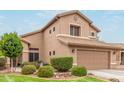Well maintained home with mature landscaping, an attached garage, and a neutral color palette at 6112 N Almanza Ln, Litchfield Park, AZ 85340
