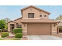 Beautiful two-story home with a large, attached two-car garage and well-kept landscaping at 6112 N Almanza Ln, Litchfield Park, AZ 85340