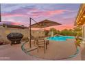 Inviting backyard pool area with covered patio and desert landscaping, perfect for outdoor entertaining at 6126 W Sweetwater Ave, Glendale, AZ 85304