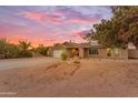 Charming single-story home featuring a brick facade, two-car garage, and desert landscaping at 6126 W Sweetwater Ave, Glendale, AZ 85304