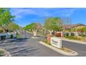 Elegant community entrance with a gated entry, manicured landscaping, and a welcoming sign for Claremont Estates at 722 W Claremont St, Phoenix, AZ 85013