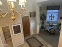 Welcoming foyer showcasing a chandelier, elegant rug, and entry to the dining area with bright light at 7318 E Woodsage Ln, Scottsdale, AZ 85258