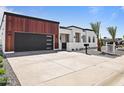 Modern single-story home featuring wood and stucco facade, black trim, and desert landscaping at 7325 E Virginia Ave, Scottsdale, AZ 85257