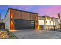 Contemporary home featuring a sleek black garage door and elegant wood accents at 7325 E Virginia Ave, Scottsdale, AZ 85257