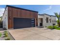 Home featuring a spacious driveway and a striking wood-paneled garage with modern design at 7325 E Virginia Ave, Scottsdale, AZ 85257