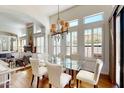 Bright dining room features a glass table, hardwood floors, and a stylish chandelier at 7705 E Doubletree Ranch Rd # 36, Scottsdale, AZ 85258