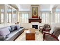 Open-concept living room featuring a fireplace, large windows, hardwood floors, and contemporary decor at 7705 E Doubletree Ranch Rd # 36, Scottsdale, AZ 85258