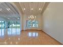 Spacious living room featuring a chandelier, light wood floors, and natural light at 8262 E Vista De Valle --, Scottsdale, AZ 85255