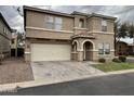 Two-story home with a two car garage and arched front entry on a cloudy day at 8504 E Lindner Ave, Mesa, AZ 85209
