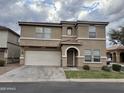 Two-story home with a two car garage and arched front entry on a cloudy day at 8504 E Lindner Ave, Mesa, AZ 85209